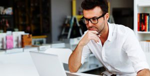 IT man working on laptop representing OnX Canada Managed Services