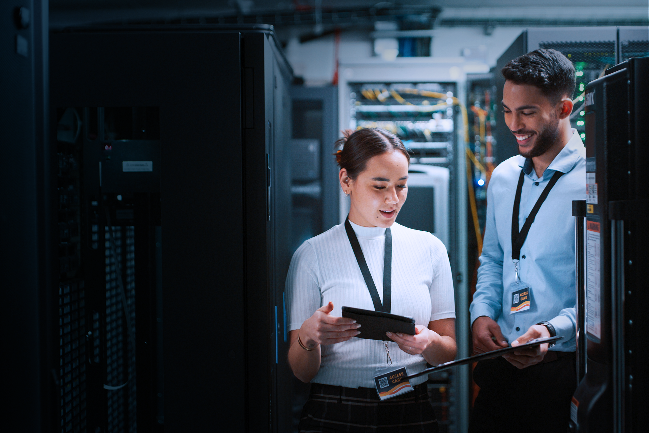 two IT professionals looking at tablets from IT consulting services
